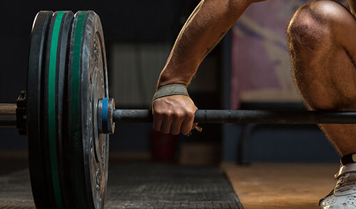 Person holding heavy looking barbell