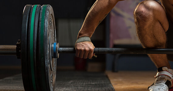 Person holding heavy looking barbell