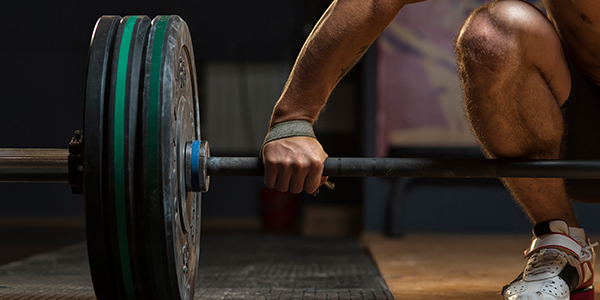 Person holding heavy looking barbell