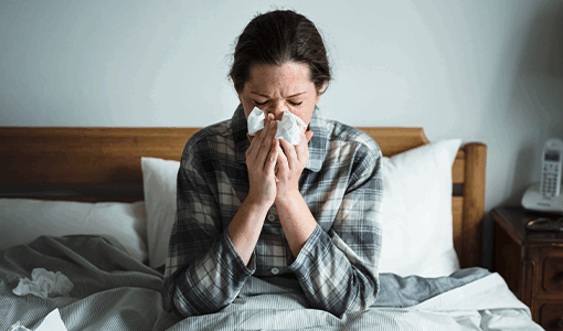 Woman in bed with a cold