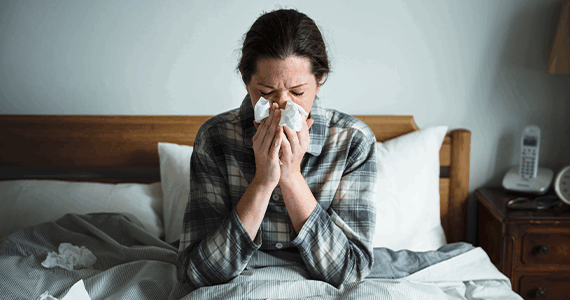 Woman in bed with a cold