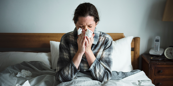 Woman in bed with a cold