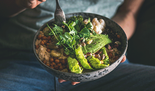 Buddha bowl with hummus, vegetable, salad, beans, couscous and avocado
