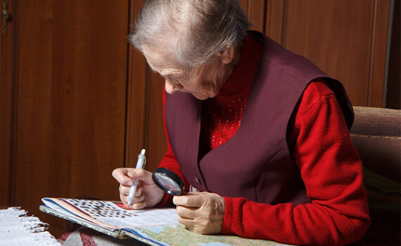 Senior woman solving a crossword puzzle
