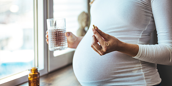 A pregnant woman taking a multivitamin